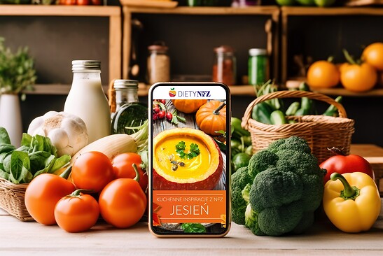 Zdjęcie ilustracyjne warzyw i telefonu z wyświetlonym e-bookiem NFZ